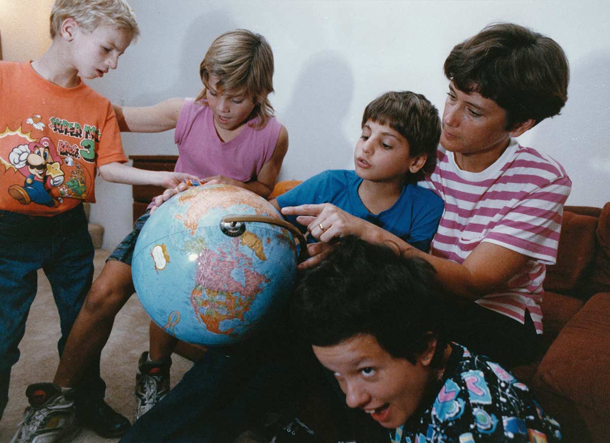 Kids looking at globe