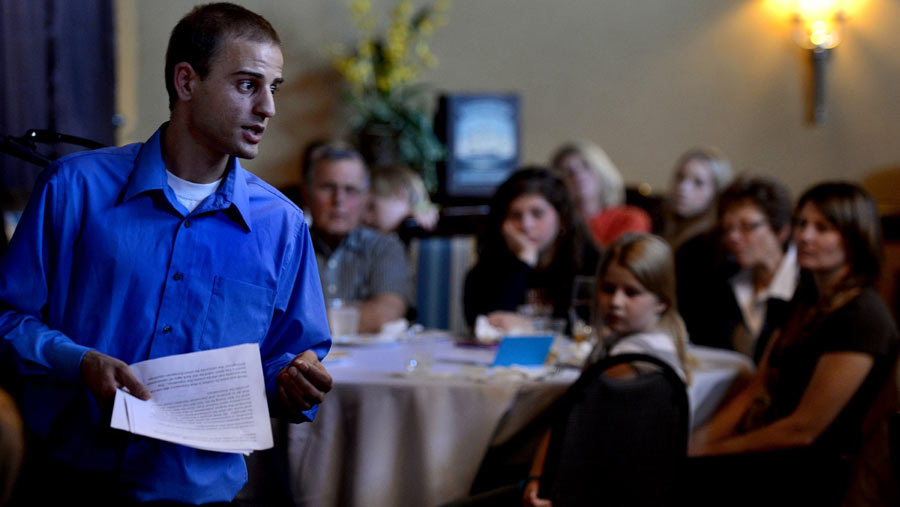 Izidor speaking to a group