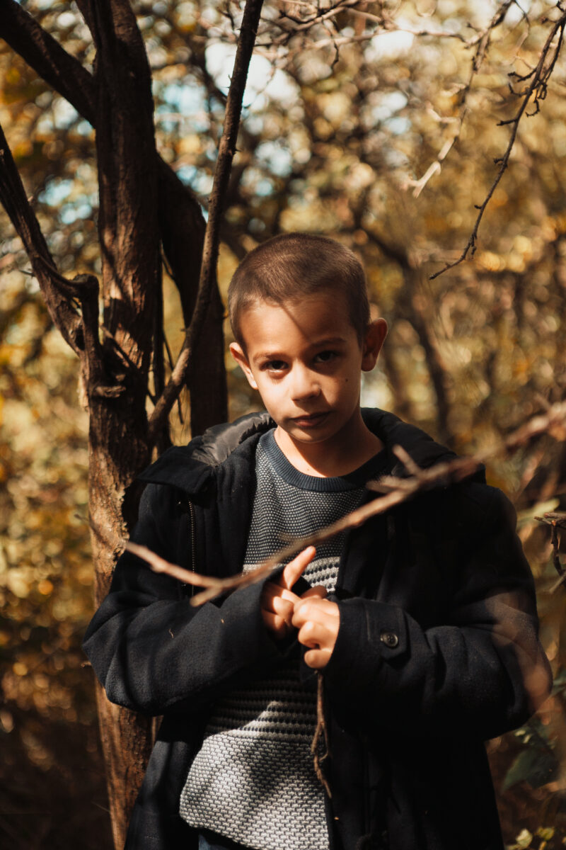 Child Izidor standing in the woods