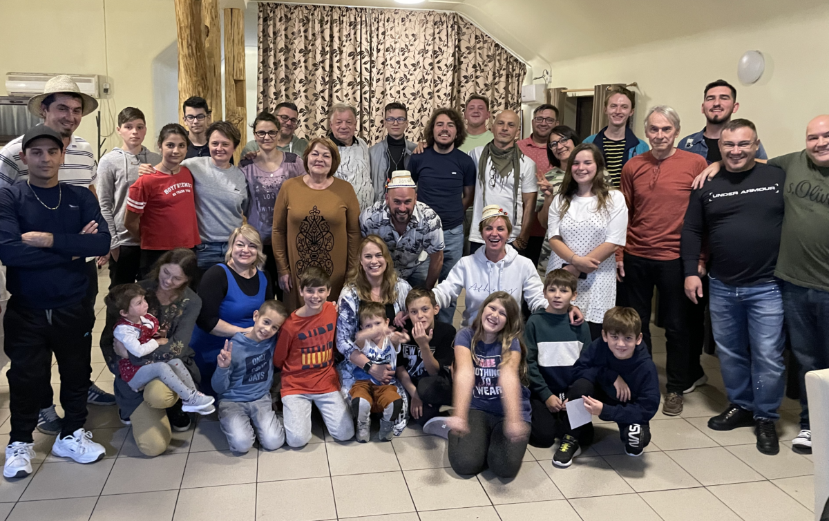 Group photo of 36 smiling children and adults