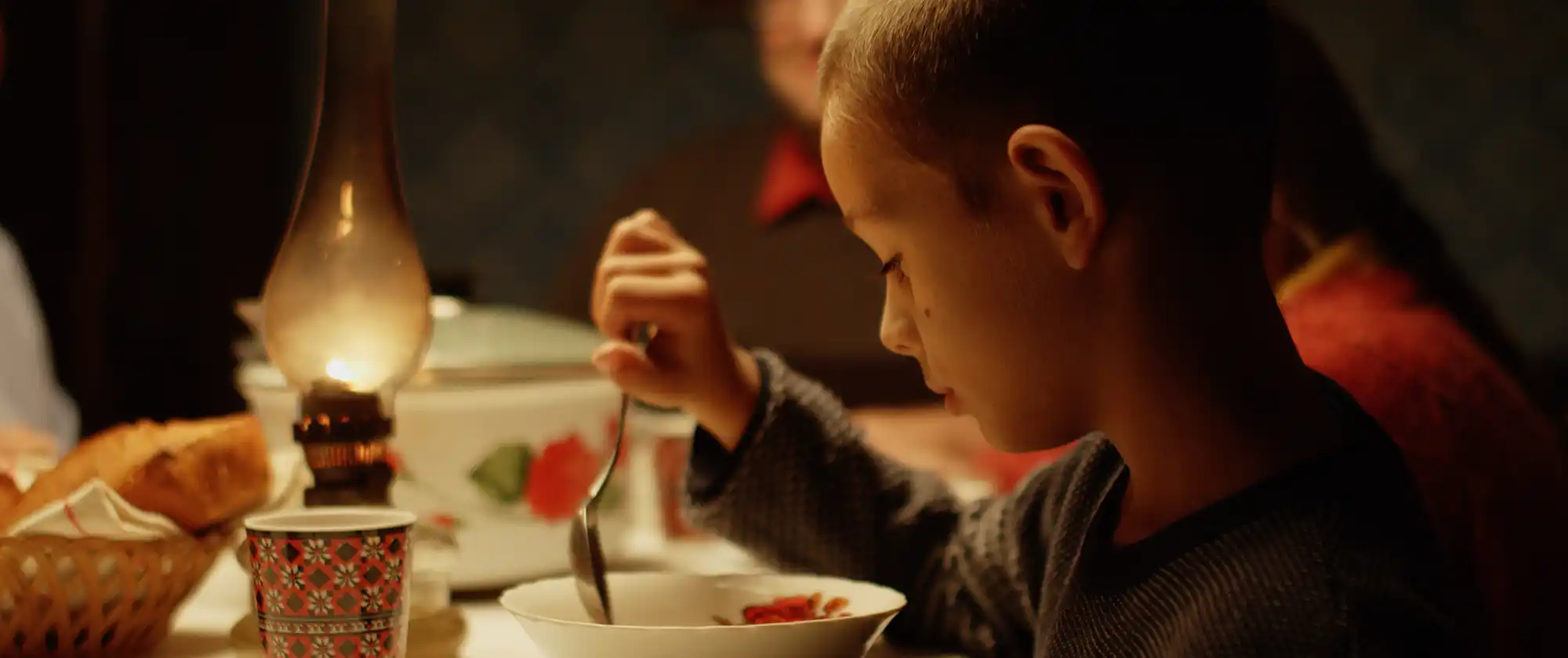 Izidor eating dinner at Onisa's house