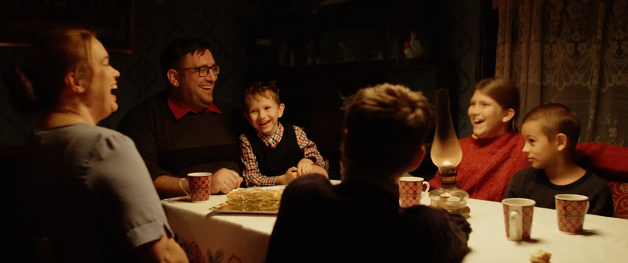 People around Oneida's dinner table, laughing