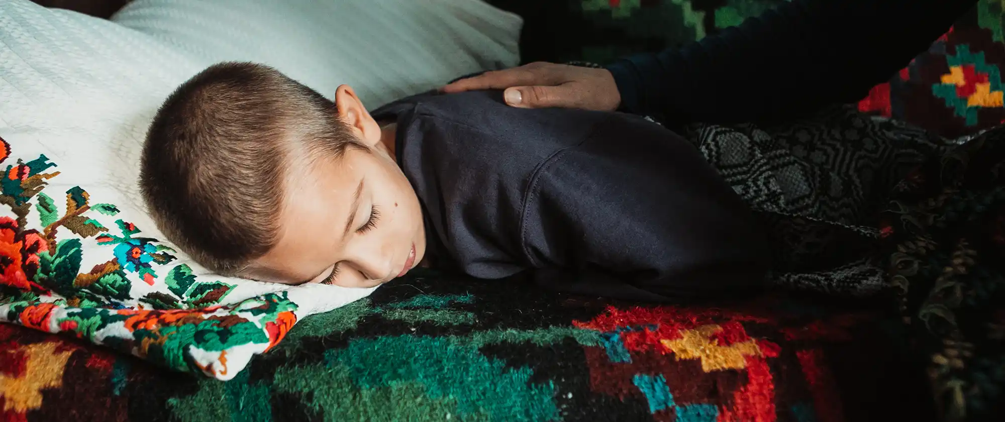 Izidor laying down to sleep at Onisa's house