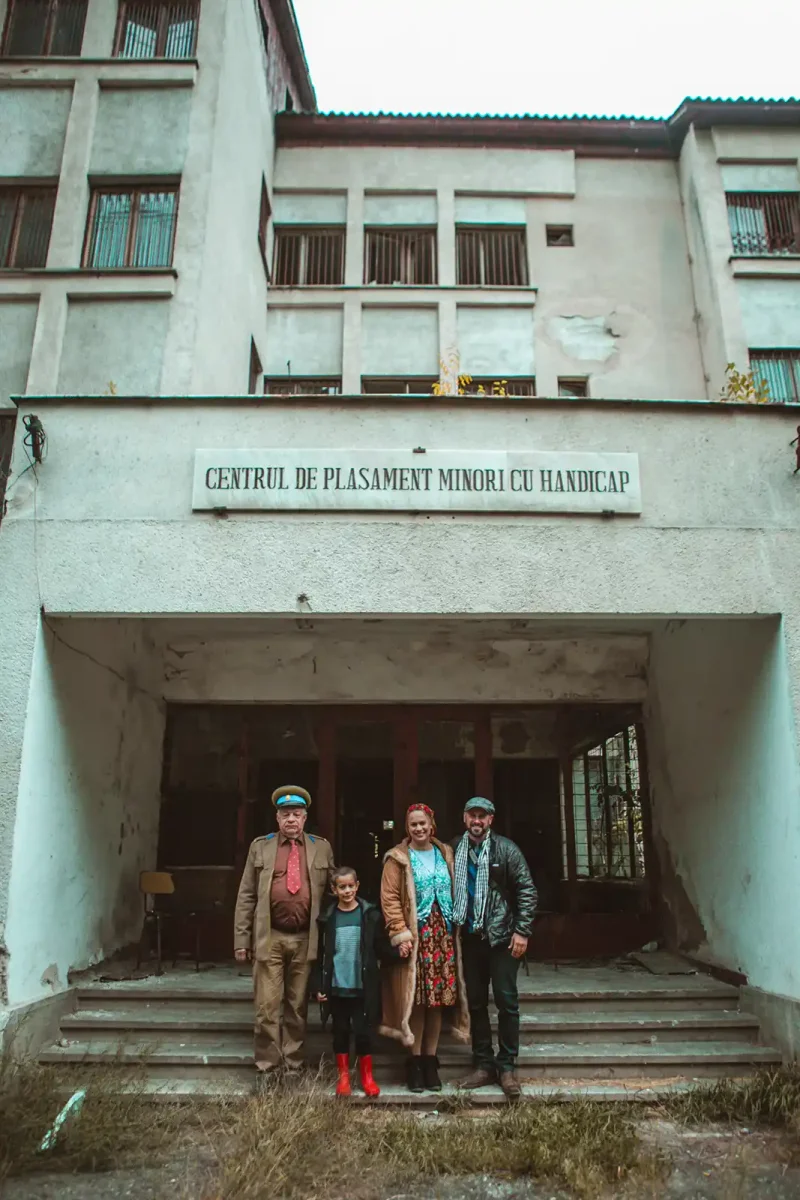 Live actors standing outside the real Home Hospital