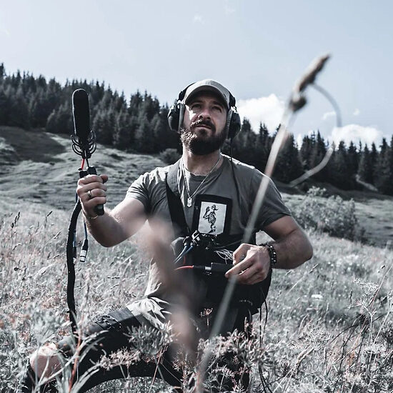 Ben Jacquier with sound equipment on a mountainside